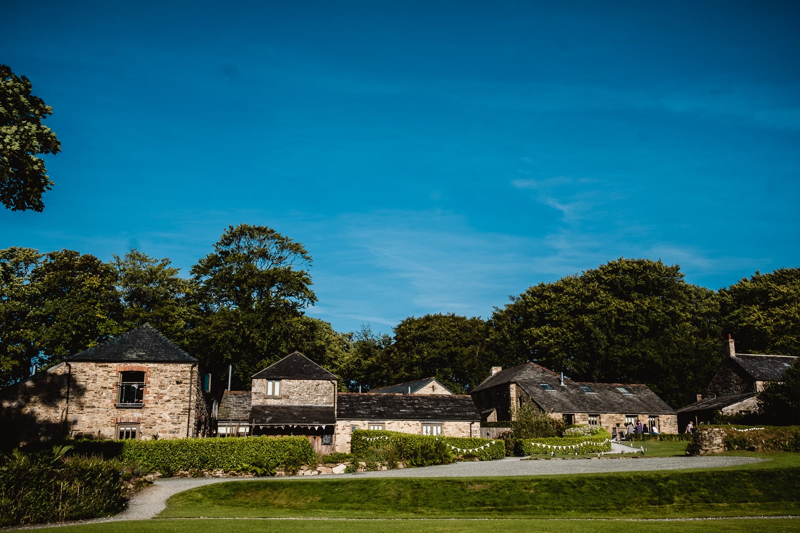A wide shot of the barns, garden venue and cottages at Trevenna